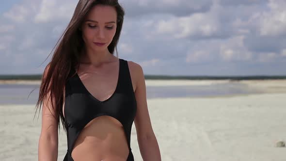 Beautiful Woman in Black Swimwear Walking Along Seaside