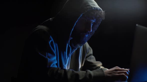Side View of Thoughtful Wearing Hooded Computer Hacker Thinking Solving Problem, Slow Motion.