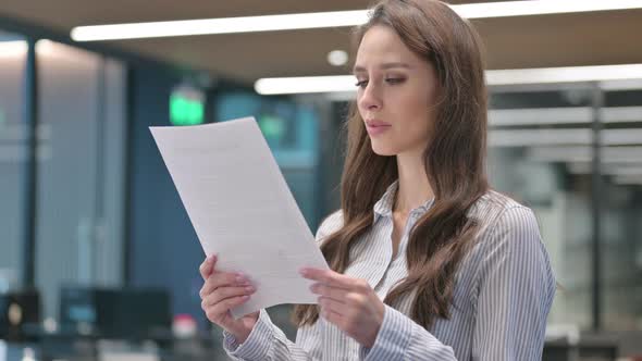 Portrait of Young Businesswoman Reading Documents