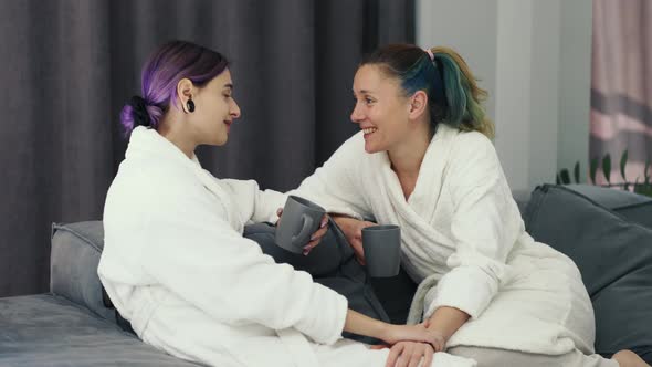 Happy Pregnant Woman and Her Girlfriend Spending Time Together at Home in Bathrobe