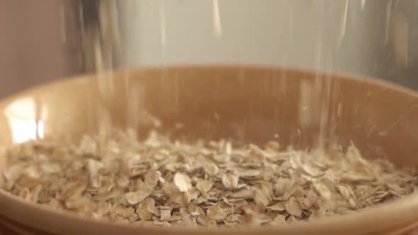 Oatmeal Filling a Clay Plate Closeup in Slow Motion