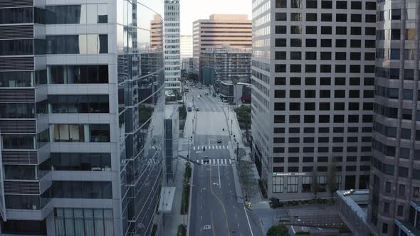 Flying over a downtown road in Los Angeles with empty streets in the middle of the day due to the gl