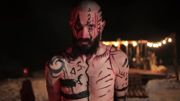 Formidable Aggressive Viking Warrior with Traditional Northern Tattoos Runes