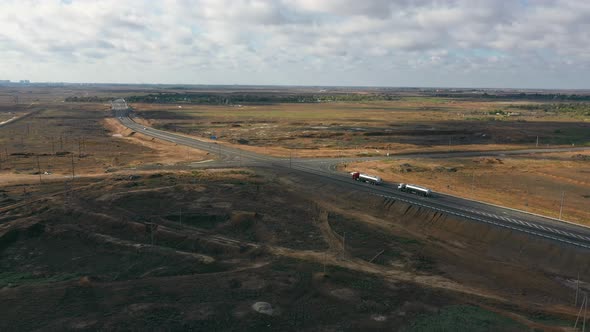 Trucks are Driving Along a Suburban Highway