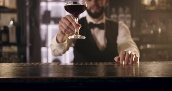 Close-up Shooting. The Bartender Is Making Presentations a Cocktail To the Client. 