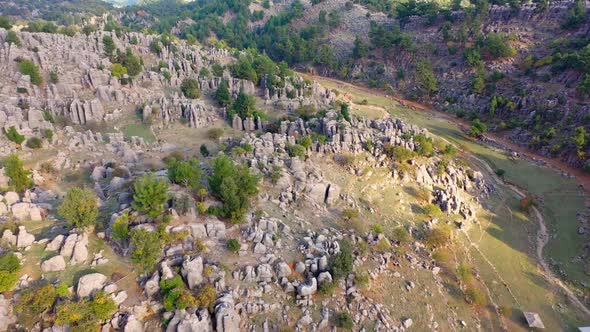 Panoramic Drone View of Mountain Valley with Rock Formations and Green Forests