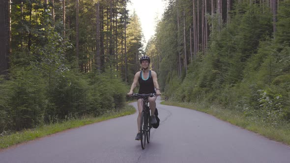 Adventurous Woman Bike Riding on a Trail in Forest