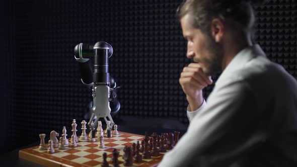 Robot Playing Chess with a Man, the Confrontation Between Man and Artificial Intelligence