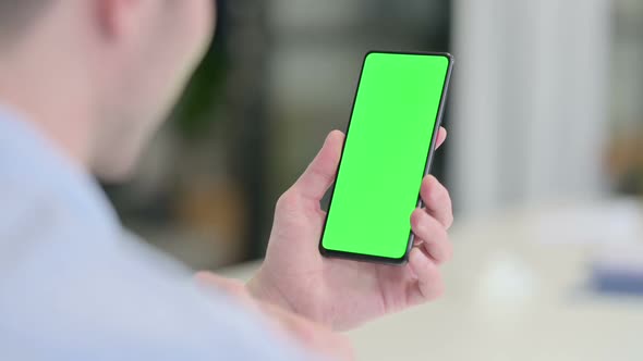 Rear View of Young Man Using Smartphone with Chroma Screen