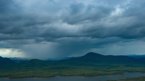 Thunderstorm and black clouds moving over the mountains. alt