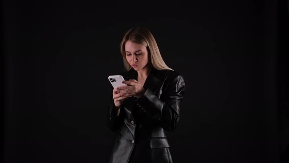 Blonde Woman in Black Jacket Taking a Selfie