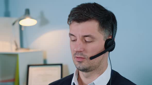 Close-up of Caucasian Call Center Agent Talking in Headset on Phone