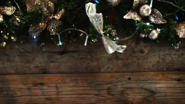 Wreath with christmas lights and decoration on a plank