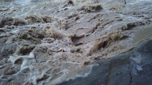 River flowing after heavy rain. Water stream After strong rain. Dirty and turbulent water after rain