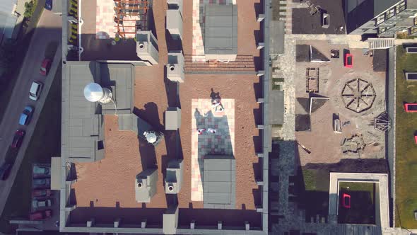 Aerial View on Top Karate Athletes Train and Play Sports on the Roof of a High-rise Building in the