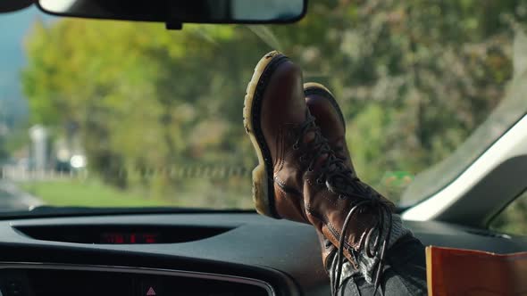 Young Woman Enjoys Traveling Car By Sticking Out Her Legs