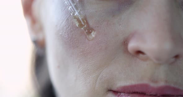 Woman Applying Antiaging Serum on Face Skin Closeup  Movie