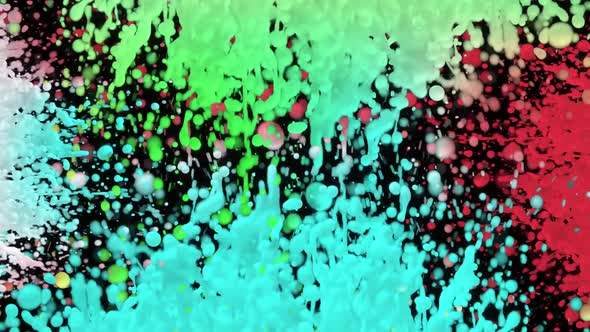 Colored Drops of Milk Splatter From Different Sides of Screen Against Black Background
