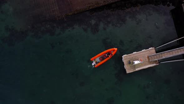People On An Orange Speedboat Docking In The Portside Of Reykjavik, Iceland. Aerial Top View