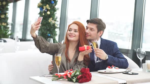 Positive Lady and Man in Tux Take Photo of Themselves