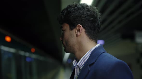 Side View of Businessman Waiting for Train in Subway