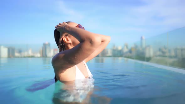 Young asian woman enjoy around outdoor swimming pool for leisure