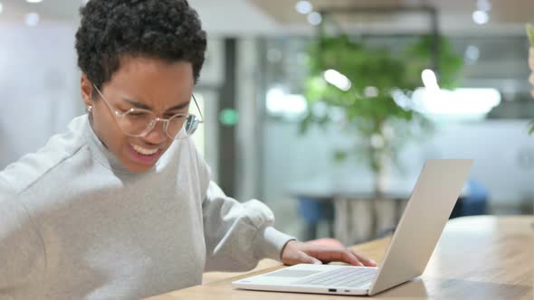 Casual African Woman with Laptop Having Back Pain 