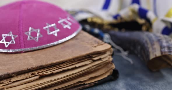 Jewish Prayer Items Tallit and Kippa on a Shofar Prayer Book of Torah Scrolls a Pointer