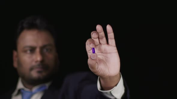 Business Man Holds Blue Pill 