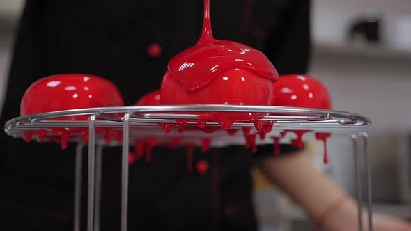 The Pastry Chef Pours Liquid Syrup on Mousse Cakes. Desserts with Mirror Glaze.