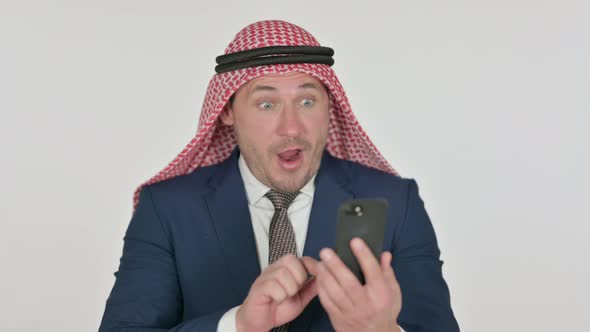 Arab Businessman Celebrating on Smartphone, White Background