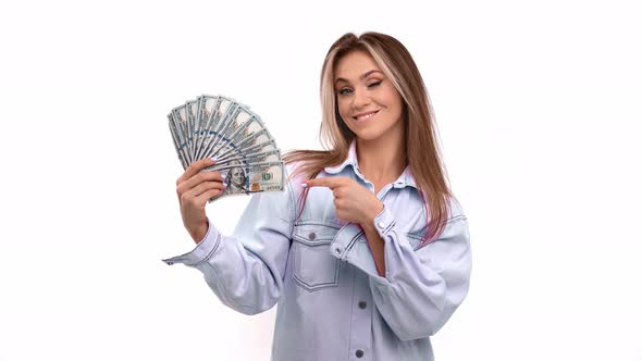 Overjoyed Woman Enjoying Smell of Cash Money Blowing Fan Posing Isolated