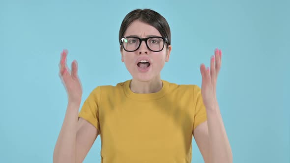 Young Woman Showing Annoyance Through Hand Gesture on Purple Background