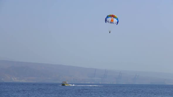 Motor Boat Tows a Special Parachute Over the Sea