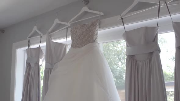 Bride and Bridesmaid Gown Hanging on Window