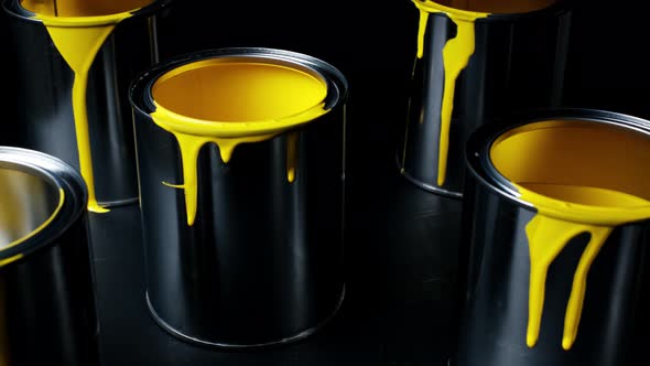 Colorful Paint Leaking Down on Wall of Metal Bucket. Isolated Over Black Background. Shot on Slider