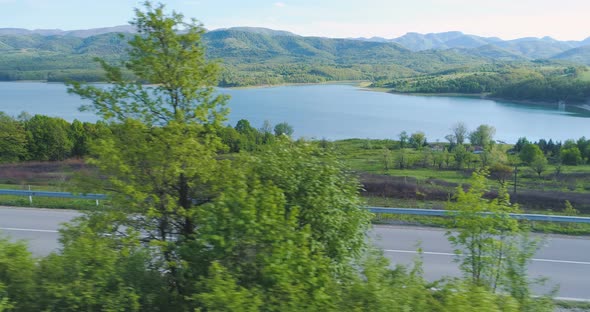 Women Jogging Together Near Lake, Practicing for Healthy Lifestyle