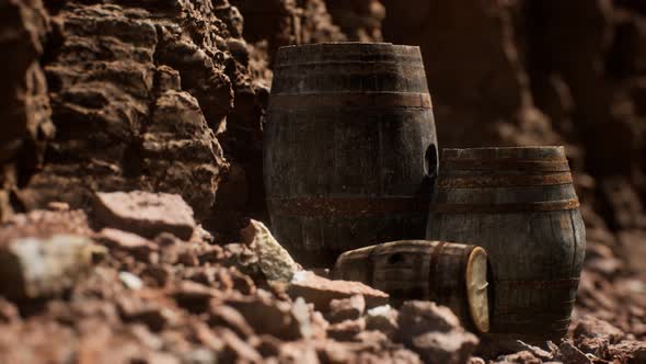 Old Wooden Vintage Wine Barrels Near Stone Wall in Canyon