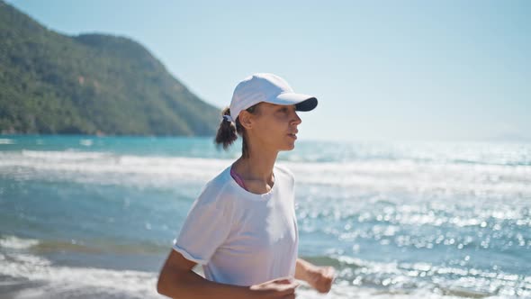 Yclose Up Oung Woman Exercising Outdoor Running with a Sea Background