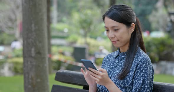 Woman use of mobile phone in the park