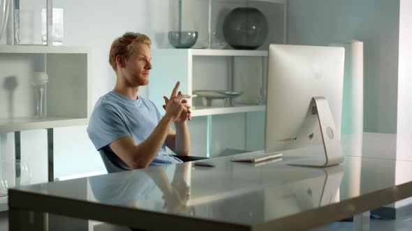 Smiling Businessman Having Video Conference with Corporate Team at Home Office