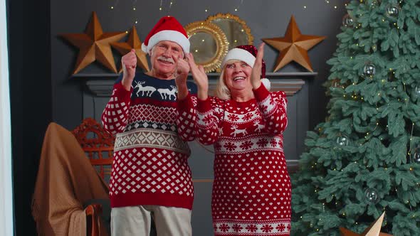 Cheerful Married Senior Couple Grandparents Celebrating Success Win Scream Rejoices on Christmas