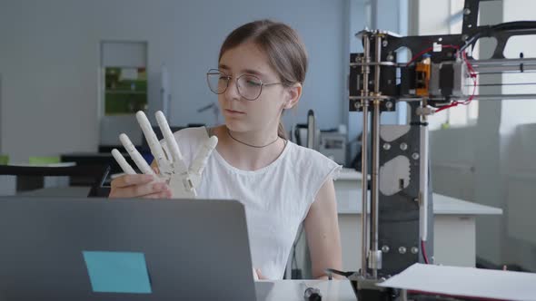 Close Up Girl with 3D Printed Hand in Her Hands