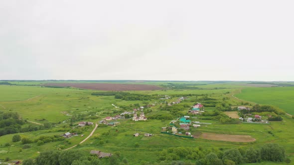 Green Open Field and a Village