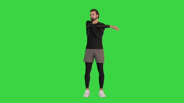 Fitness Man Doing Warm Up Exercises on a Green Screen Chroma Key