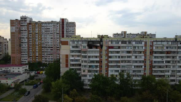 Aerial view towards a old building, with burnt apartments, in a poor slum area of Kyiv, cloudy day,