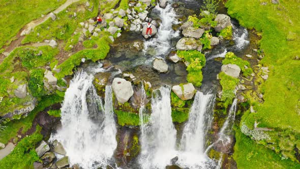 Titling Shot of a waterfall, reveal shot of a bigger waterfall