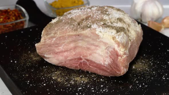 Cook Cutting Fresh Raw Pork Fillet in Domestic Kitchen with Kitchen Knife and Making Chops