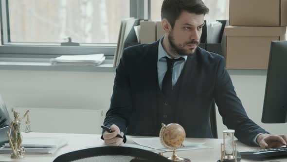 Handsome Lawyer Doing Paperwork in Office