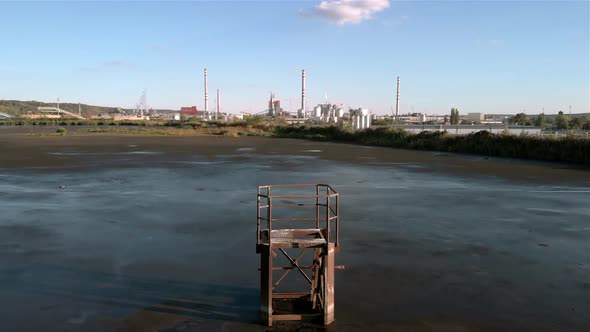 Lagoon sludge at the factory. Wide shot.